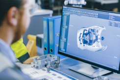 Example of man at computer prototyping/engineering NPI within the robotics field